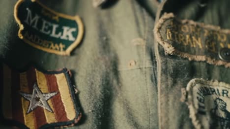 an in-depth look at a vintage military uniform showcasing various historical patches reflecting rich heritage and tales of courage and valor over time