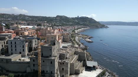 aerial drone shot over a new building under construction in the italian city of pozzuoli during on a sunny day