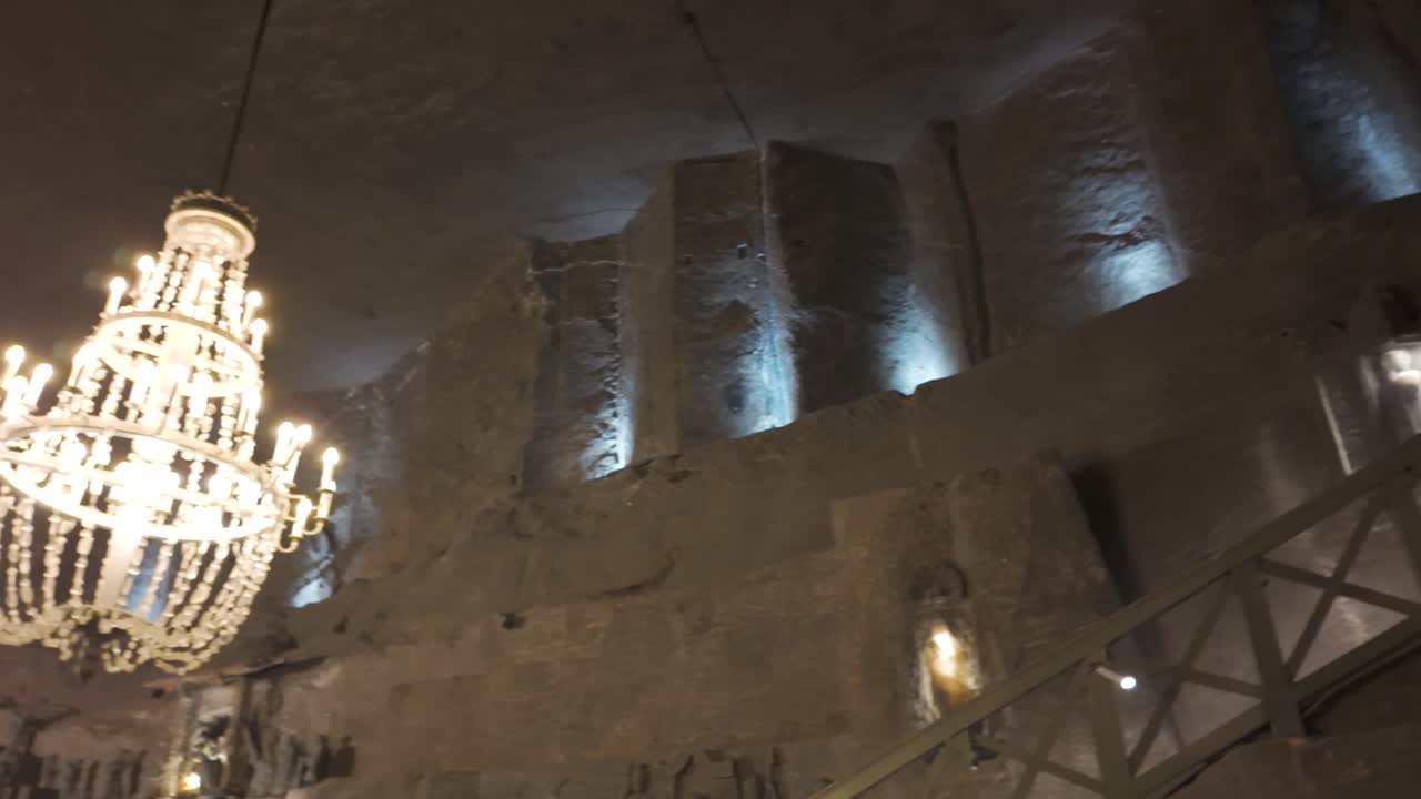 Illuminated chandelier in Poland's Wieliczka Salt Mines, adding elegance to the underground chamber
