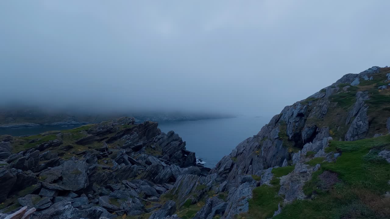 Island of Rolvsøya, rocky coast on a cloudy day, Norway. Time lapse.