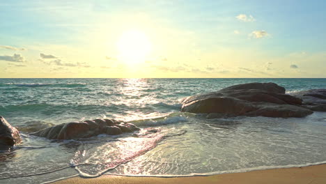 Slow-motion-waves-roll-over-large-boulders-along-the-shoreline