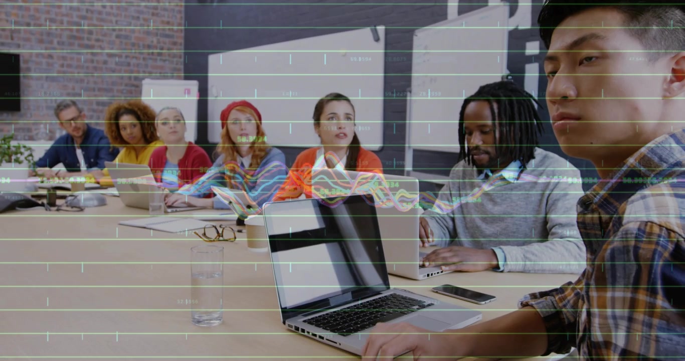 Presenter pointing to faint data graph, front man flipping pages while team responding to data