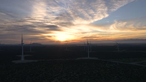 wind turbines in a desert landscape at sunset