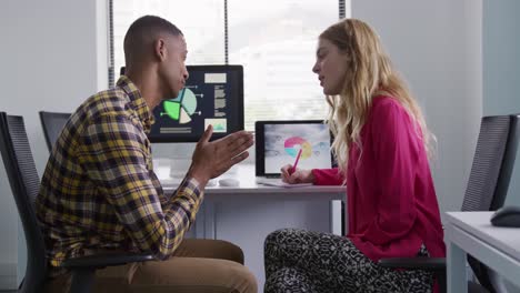 man-and-woman-working-on-computers