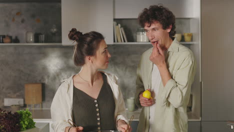 a couple prepares a healthy salad together in a modern kitchen