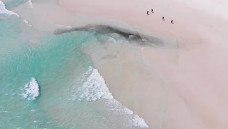 A-reveal-shot-of-a-bunch-of-diver-coming-by-from-diving-and-a-ship-at-Redang-Island,-Malaysia