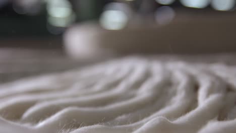 macro shot of cotton fibers during spinning process to manufacture thread