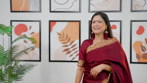 indian woman pointing left at empty copy space