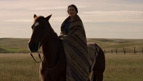 woman on horseback in a prairie field
