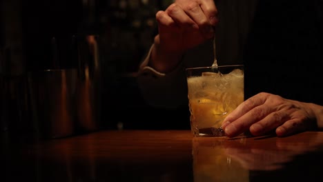 bartender stirring and serving a cocktail drink