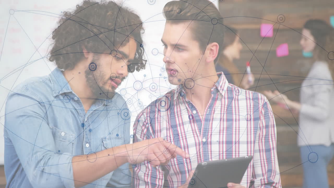 Two men discussing over tablet with network connections animation overlay