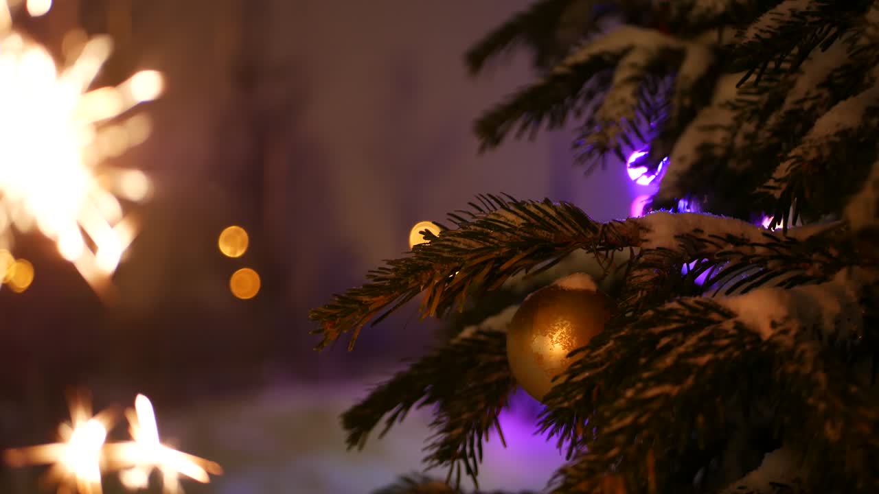 Christmas tree in snow, sparkler firework burning, New Year or Xmas bengal light