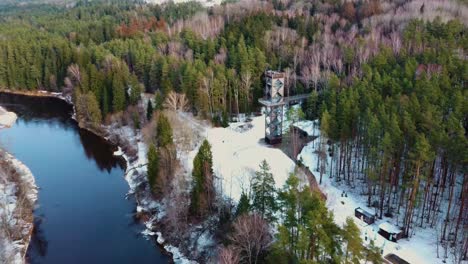 aerial view of anyksciai laju takas, treetop walking path complex with a walkway, an information center and observation tower, located in anyksciai, lithuania near sventoji river