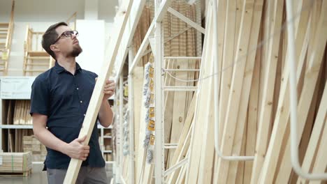 man shopping for lumber at a hardware store