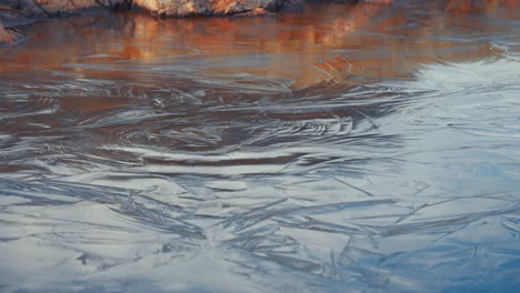 Icy-patterns-on-the-frozen-surface-of-the-small-pond-in-the-autumn-tundra