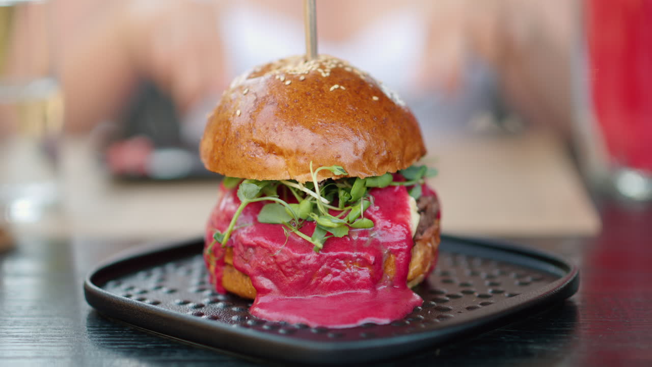 Close up burger with red sauce and green salad microplants