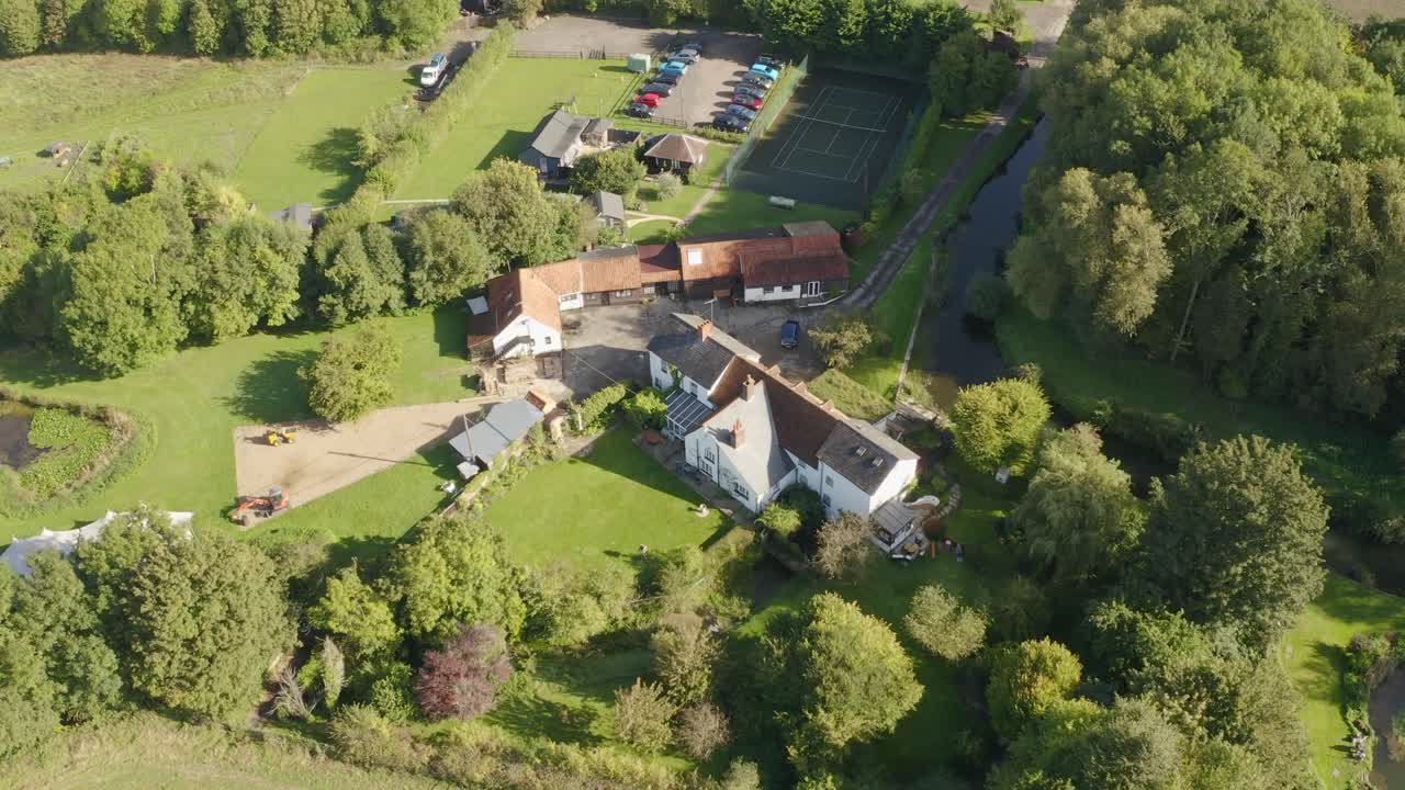 Smooth aerial establishing of Dunstable farmland with grid of green fields and roads visible