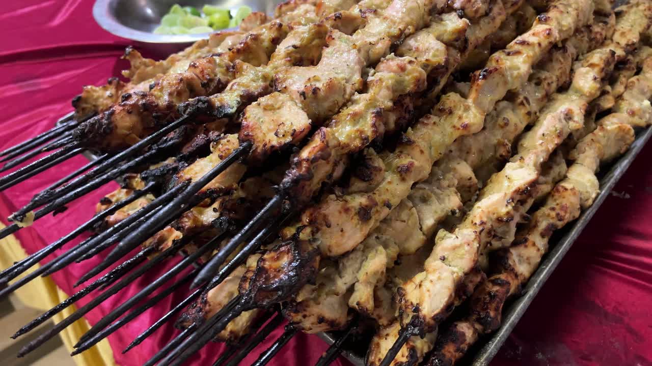 Paahdettua kana-kebabia vartaissa tarjoiltavaksi vieraille.