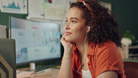woman listening to music while working on a computer