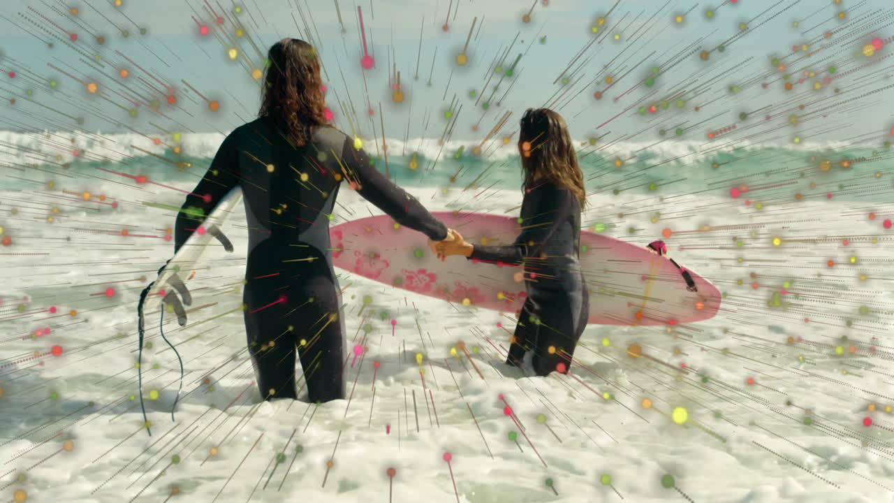 Couple holding surfboards in surf, displaying multicolored radial lines highlighting technology