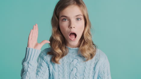 teenage caucasian girl gesturing bla bla in front of the camera.