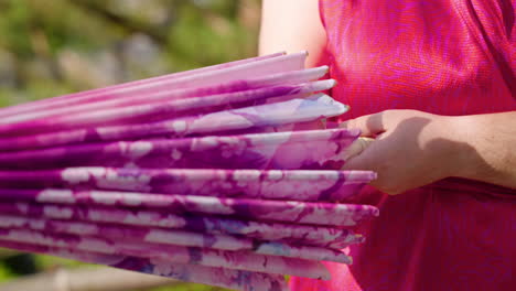 woman opening and closing traditional japanese paper umbrella in japan