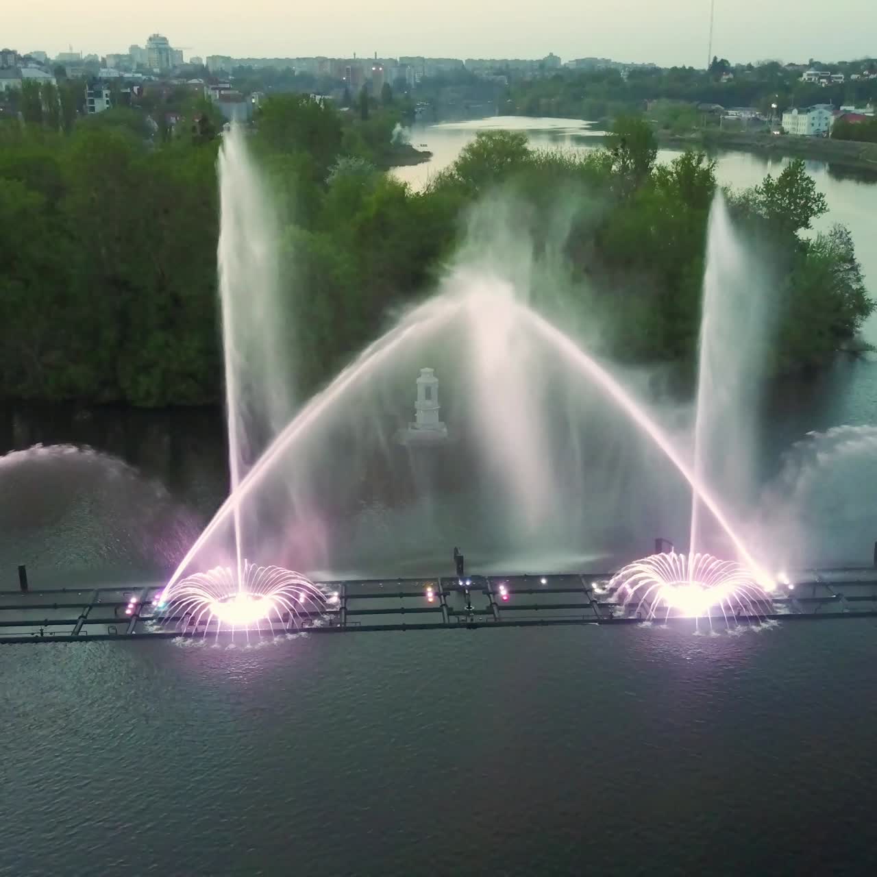 Fountain With Colorful Illuminations At Night. Aerial shot of the magic fountain - lights,colors and music spectacle at night