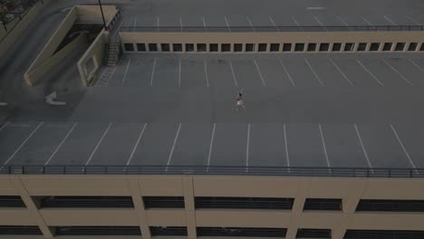 ballet dancer alone on a parkade roof in a city