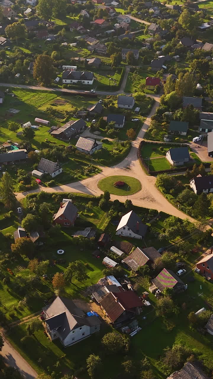 Aerial Drone Rotating Over A Small Roundabout Traffic Circle In Augsligatne Latvia.