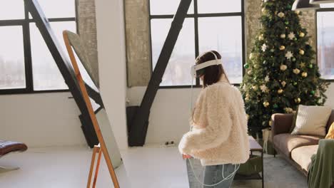 young woman wearing vr headset in front of a mirror, at christmas