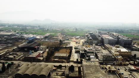 a typical industrial area in pakistan with workers and commuters going about their morning business