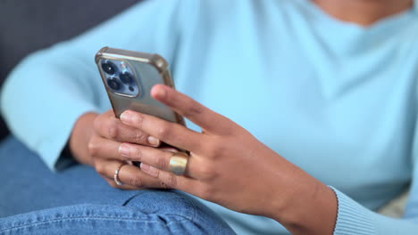 woman scrolling on a phone at home