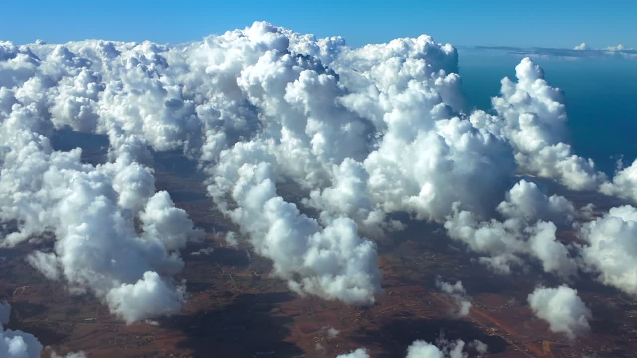 An immersive fighter jet POV from cockpit while flying at supersonic speed over tiny cottony cumulus clouds over a coastal landscape. Daylight. Ultra-realistic 4K shot