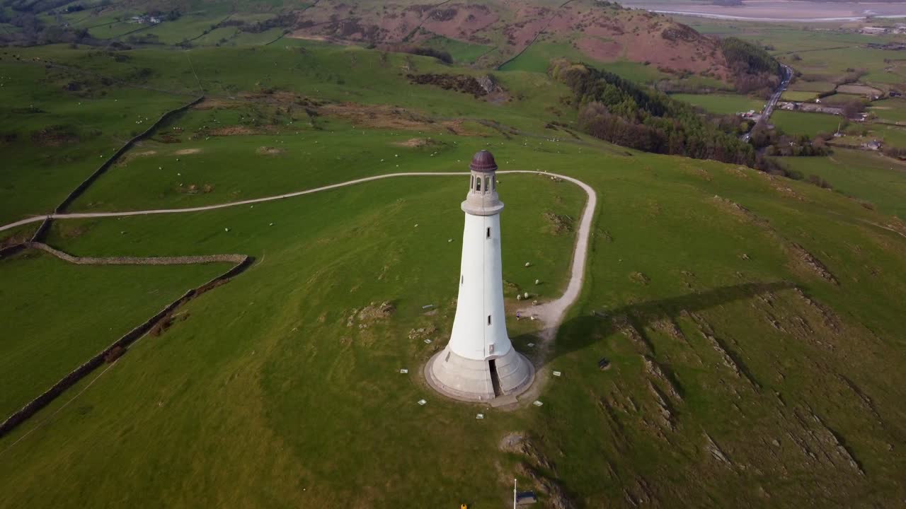 Aerial tilt-down shot of the Sir John Barrow Monument, ending with a direct top-down view of the landmark surrounded by greenery
