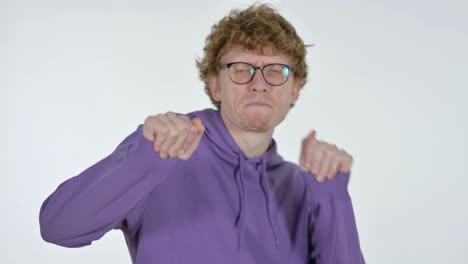 happy redhead young man dancing, white background