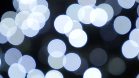 background decorative white and blue de-focused christmas lights blinking in 4k