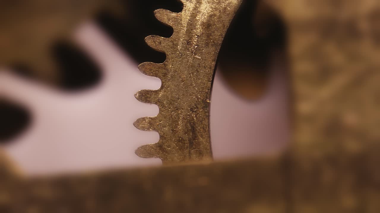 Clock movements delicate gear cog mechanism rotating in perfect timing MACRO
