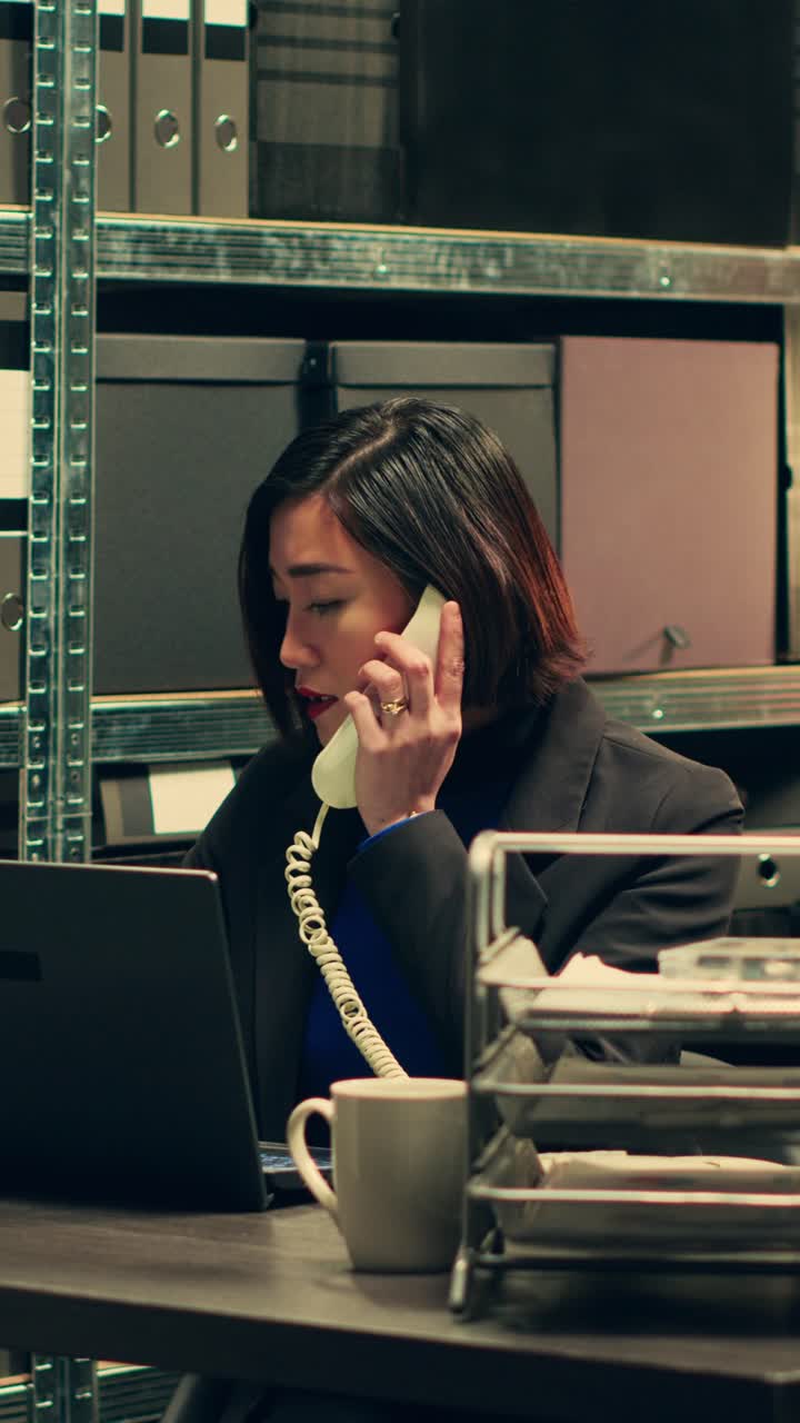 Vertical Video Private detective conducting background check on landline phone call