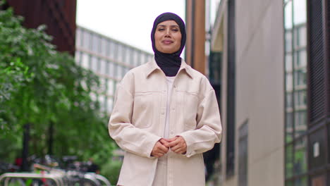 portrait of modern muslim businesswoman wearing hijab with business suit going to work standing outside office buildings 2