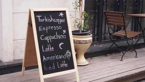 a coffee shop sign with a list of drinks on a chalkboard