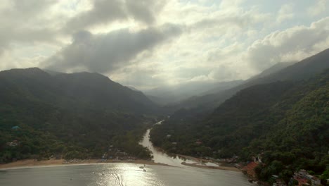 panoramic view over tuito river and yelapa beach on a cloudy day in jalisco, mexico - aerial drone shot