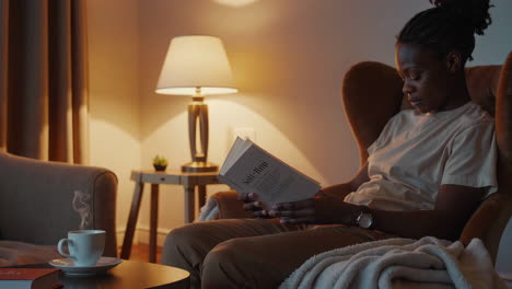 Woman Reading in a Cozy Living Room at Night
