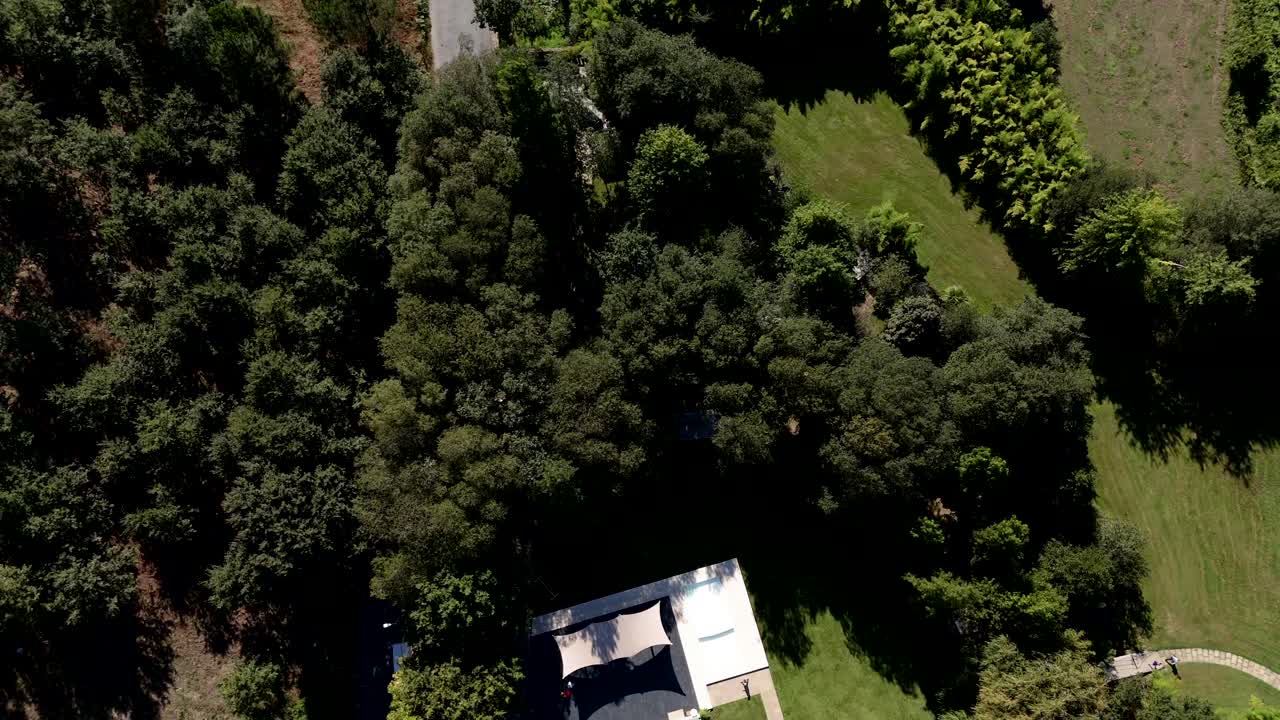 Aerial View of a Beautiful Property with a Pool and Lush Greenery