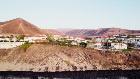 coastal town in fuerteventura with volcanic landscape and clear skies, aerial view