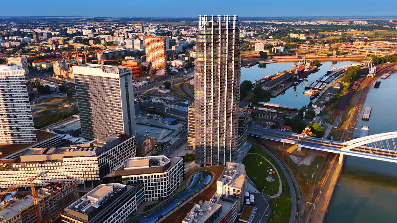 Neighborhood with modern architecture on the waterfront of the Danube. Vast scenery of Bratislava, Slovakia from aerial view