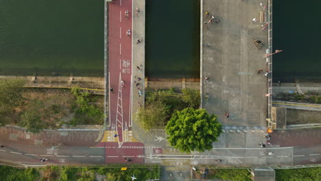 High-altitude-static-shot-of-the-start-of-two-bridges-close-to-a-park