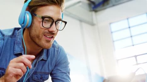 business executive listening to music on digital tablet