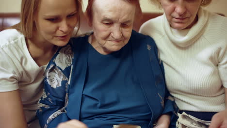 women of different age looking through old family photos