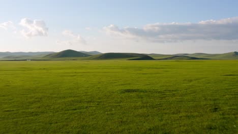 drone dolly above calm peaceful rolling hills on mongolian grassland plains