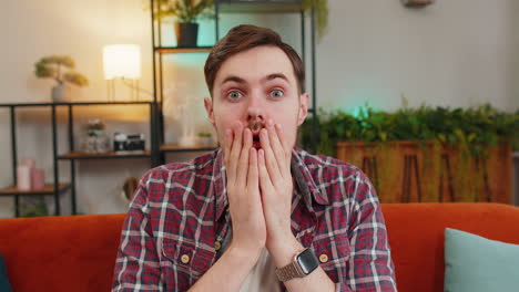 man sitting on a couch surprised